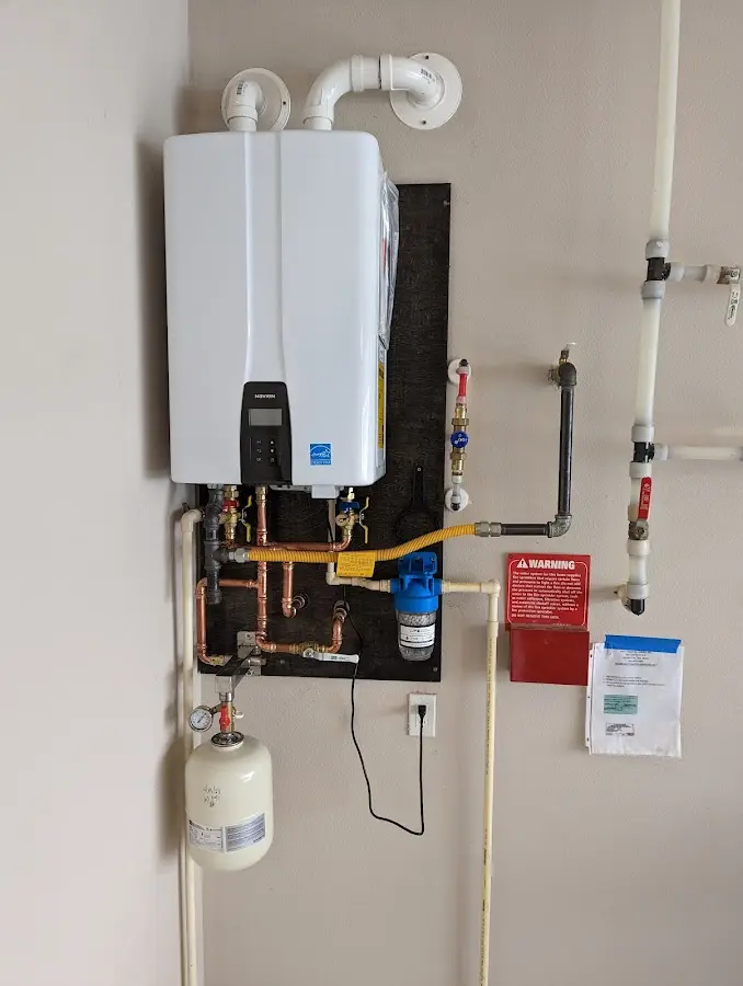 Professional plumber installing copper piping in a St. Rose home